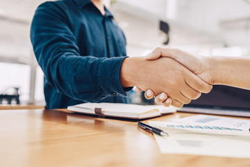 Business shaking hands, finishing up meeting. Successful businessmen handshaking after good deal.