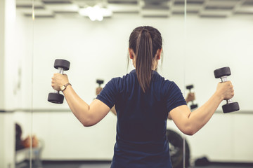 Young woman exercise by drumbell afte work