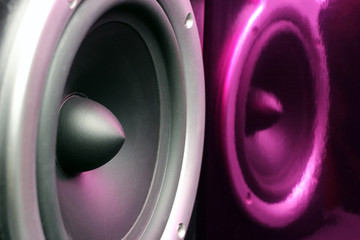 Acoustic column, musical speaker with purple reflection. Close up