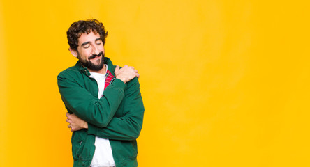 young crazy bearded man feeling in love, smiling, cuddling and hugging self, staying single, being...
