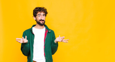 young crazy bearded man feeling clueless and confused, not sure which choice or option to pick,...