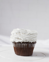 chocolate cupcake with a white ruffle buttercream