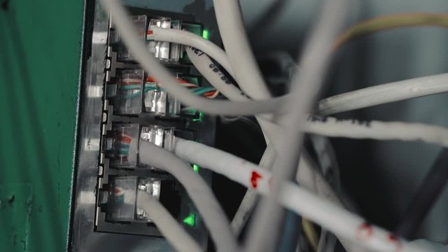Computer network. Data cables are connected to the router. Close-up. High speed internet. Switch cabinet. Tangled Cords