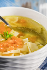 Broth - chicken soup in a bowl.