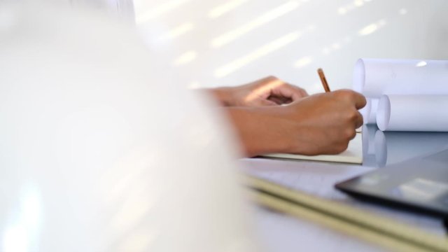 Structural design engineers work in building structure analysis.Closeup video Insturments and office for designer.drawings and computer on the table.Heavy industry business Concept Construction.b roll