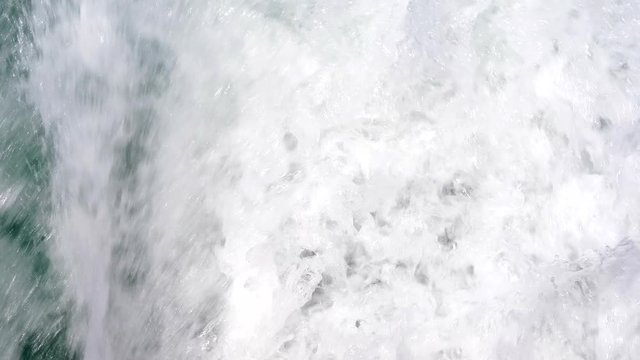 Close up of Blue Ocean sea water with wake foam of prop wash from speed boat