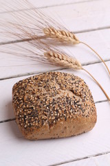 delicious bread rolls on colored background