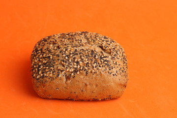 delicious bread rolls on colored background