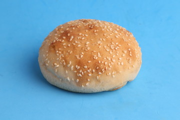 delicious bread rolls on colored background