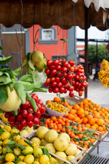 Fototapeta na wymiar Huge lemons, tangerines and cherry tomatoes are sold on the Amalfi coast in Italy.