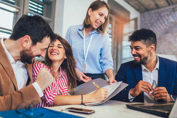 Young couple signing a contract  on a meeting with investment agent in the office.