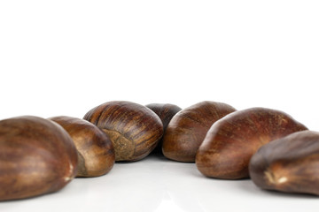 Group of seven whole edible brown chestnut isolated on white background
