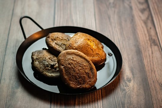 High angle shot of delicious torrejas de pinol  placed on a plate with a blurred background