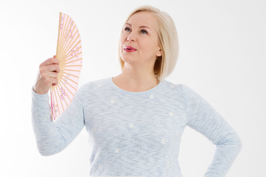 Beautiful Middle Aged Woman With Menopause Blowing By Fan. Hormone Replacement Therapy And Mature Woman Healthcare. Mid Age Happy Women Lifestyle. Senior Woman Isolated On White Background