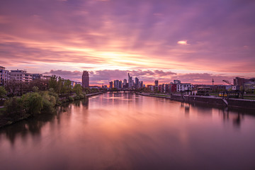 Beautiful sunset over Frankfurt Skyline, reflection on main river