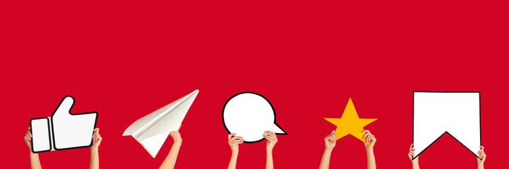 Hands holding the signs of social media on red studio background, flyer. Copyspace for your text or...