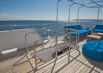 Fototapeta na wymiar Table and chairs on deck of a luxury motor yacht