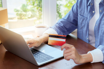 Beautiful Asian woman in casual using laptop technology for running small business start up...