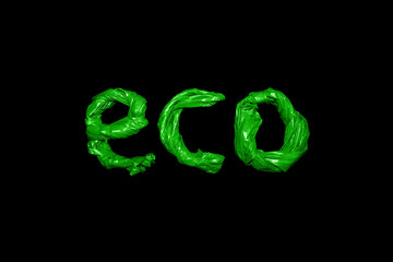 Inscription Eco from green plastic bags isolated on black background. Protection ecology of the earth of nature