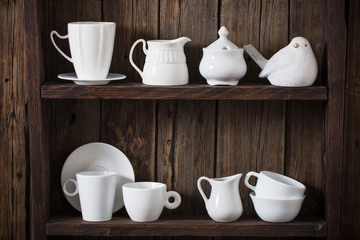 white kitchen dishware on old dark wooden background