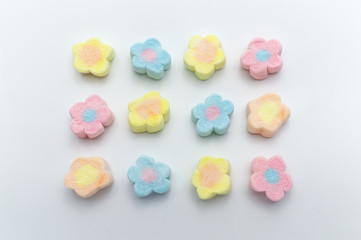 Pastel sweet flowers shape of marshmallows on white background.