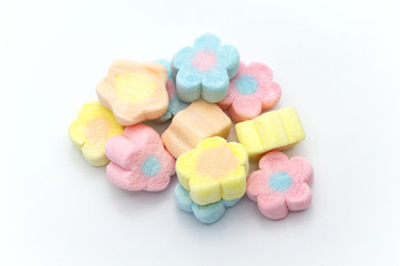 Pastel sweet flowers shape of marshmallows on white background.