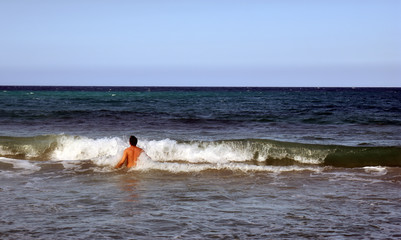 the guy is swimming in the Atlantic ocean. Dominican Republic