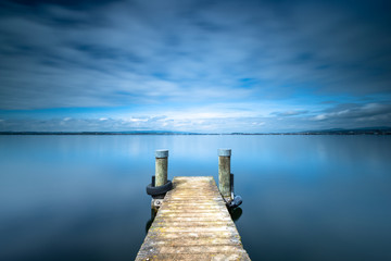 Fototapeta na wymiar Long exposure landscape. Pier on the lake.