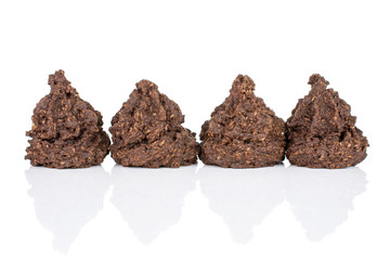 Group of four whole homemade brown coconut cocoa biscuit isolated on white background