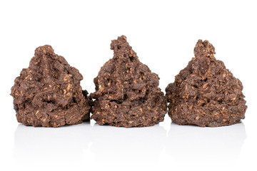 Group of three whole homemade brown coconut cocoa biscuit in row isolated on white background