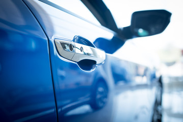 Close up photo of New blue car door. Concept for car rental.,New cars available for sale, parked in...