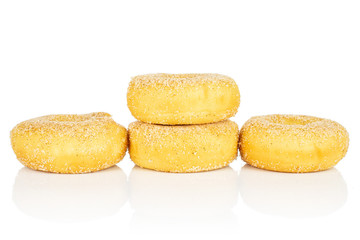 Group of four whole sweet golden mini cinnamon donut isolated on white background