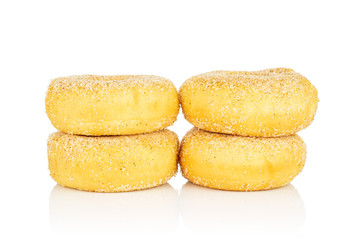 Group of four whole sweet golden mini cinnamon donut in two columns isolated on white background