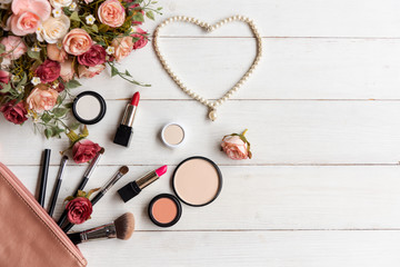 Naklejka premium Valentine Gift. Makeup cosmetics tools background and beauty cosmetics, products and facial cosmetics package lipstick with flower rose, Pearl necklace,
