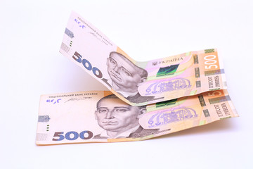 Obraz na płótnie Canvas Two new banknotes in denominations of 500 Ukrainian hryvnias isolated on a white background with shadow. European money exchange. Ukraine currency
