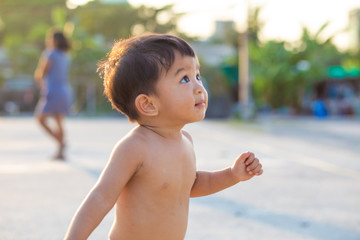 Little toddler asian baby boy walking along playgound outdoor the street new activity experience