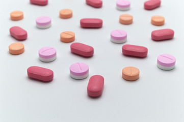Obraz na płótnie Canvas Different colorful drugs or medicine pills tablet supplements for the treatment and health care on a white background and Selective focus.