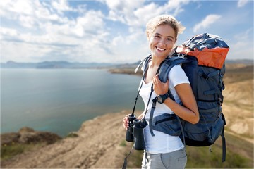 Travels female happy and smiling during a hike