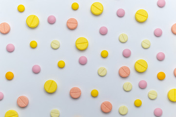Different colorful drugs or medicine pills tablet supplements for the treatment and health care on a white background.