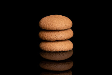 Group of three whole sweet brown chocolate sponge biscuit isolated on black glass