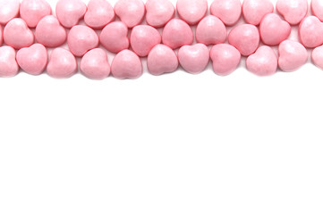 Valentine day isolated on white background with pink hearts candy. Copy space.