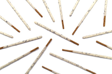 Chocolate biscuit stick coated with milk flavour confectionery and crushed cookies and cream taste isolated on white background.