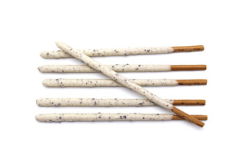 Chocolate biscuit stick coated with milk flavour confectionery and crushed cookies and cream taste isolated on white background.