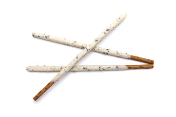 Chocolate biscuit stick coated with milk flavour confectionery and crushed cookies and cream taste isolated on white background.