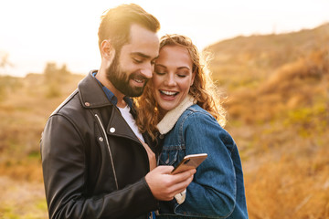 Beautiful young happy stylish couple wearing jackets