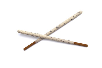 Chocolate biscuit stick coated with milk flavour confectionery and crushed cookies and cream taste isolated on white background.