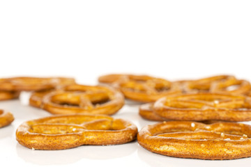 Lot of whole salty brown pretzel isolated on white background