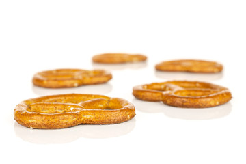 Group of five whole salty brown pretzel isolated on white background