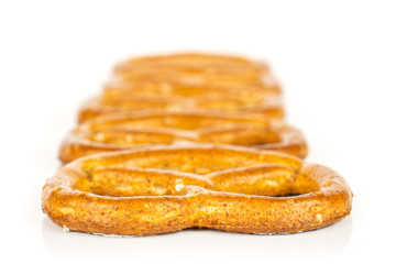 Group of five whole salty brown pretzel isolated on white background