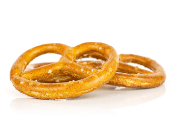 Group of three whole salty brown pretzel isolated on white background